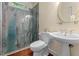 Modern bathroom features marble shower and a pedestal sink with a mirror at 405 Silver Creek Trl, Chapel Hill, NC 27514