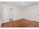 Spacious bedroom with hardwood floors, white walls, and white trim throughout the house at 405 Silver Creek Trl, Chapel Hill, NC 27514