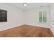 Bedroom featuring hardwood floors, window with plantation shutters, and neutral paint at 405 Silver Creek Trl, Chapel Hill, NC 27514