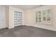 Spacious bonus room with window shutters, neutral paint, and built-in shelves at 405 Silver Creek Trl, Chapel Hill, NC 27514
