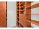 Walk-in closet with wood shelves and built-in storage at 405 Silver Creek Trl, Chapel Hill, NC 27514