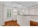 Walk-in closet featuring hardwood floors, center island, shelves, and built-in storage at 405 Silver Creek Trl, Chapel Hill, NC 27514