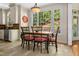 Bright dining room with large window and a view of the landscaped yard at 405 Silver Creek Trl, Chapel Hill, NC 27514