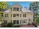 Rear exterior view of a bright two-story home with a brick patio and lush landscaping at 405 Silver Creek Trl, Chapel Hill, NC 27514