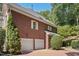 Brick home showcasing a two-car garage and manicured landscaping at 405 Silver Creek Trl, Chapel Hill, NC 27514