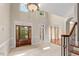 Bright foyer with tile flooring, transom windows, and hardwood front door with sidelights at 405 Silver Creek Trl, Chapel Hill, NC 27514