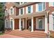 Grand brick home with white columns framing the entrance, decorative lion statues, and a welcoming brick walkway at 405 Silver Creek Trl, Chapel Hill, NC 27514