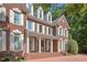 Stately brick residence with white columns, decorative lion statues, and meticulously maintained landscaping at 405 Silver Creek Trl, Chapel Hill, NC 27514