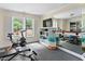 Home gym with mirrors, exercise equipment, and view of landscaped backyard at 405 Silver Creek Trl, Chapel Hill, NC 27514