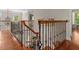 Beautiful hallway with wrought iron railing overlooking staircase and lower level at 405 Silver Creek Trl, Chapel Hill, NC 27514
