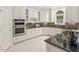 Updated kitchen with stainless steel appliances, white cabinets, and granite countertops at 405 Silver Creek Trl, Chapel Hill, NC 27514