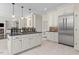 Bright kitchen with an island cooktop, stainless steel appliances, and white cabinets at 405 Silver Creek Trl, Chapel Hill, NC 27514