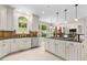 Open kitchen with stainless steel appliances, white cabinets, and an island cooktop at 405 Silver Creek Trl, Chapel Hill, NC 27514