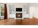 Living room features a fireplace, built in bookcases, and hardwood flooring at 405 Silver Creek Trl, Chapel Hill, NC 27514