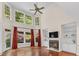 Living room featuring tall windows and ceilings, a fireplace, and hardwood flooring at 405 Silver Creek Trl, Chapel Hill, NC 27514