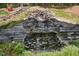 Tiered rock waterfall creates a serene backyard oasis at 405 Silver Creek Trl, Chapel Hill, NC 27514