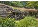 Beautiful stone waterfall feature with lush greenery at 405 Silver Creek Trl, Chapel Hill, NC 27514