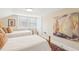 Bright bedroom featuring two twin beds, a sailboat painting, and ample natural light at 411 Circle Dr, Burlington, NC 27215