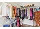 This walk-in closet has plenty of storage, with custom shelving and hanging racks for all your clothing and accessories at 411 Circle Dr, Burlington, NC 27215