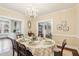 Formal dining area with oval table, ornate chandelier, and access to kitchen and living areas at 411 Circle Dr, Burlington, NC 27215