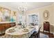 Formal dining room featuring a crystal chandelier, access to butler's pantry, and vintage decor at 411 Circle Dr, Burlington, NC 27215