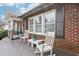 Inviting front porch with brick siding, rocking chairs, and a small table, perfect for relaxing at 411 Circle Dr, Burlington, NC 27215