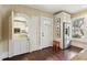Unique kitchen features a dutch door, stainless refrigerator, and charming breakfast nook at 411 Circle Dr, Burlington, NC 27215