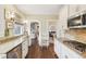 Bright kitchen with stainless steel appliances, granite counters, and white cabinets at 411 Circle Dr, Burlington, NC 27215