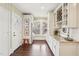 Butler's pantry featuring wine rack, stainless steel refrigerator, and natural light at 411 Circle Dr, Burlington, NC 27215