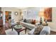 Cozy living room featuring hardwood floors, neutral furniture, and ample natural light from the shuttered windows at 411 Circle Dr, Burlington, NC 27215
