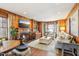 Warm wood-paneled living room with a fireplace, TV, bookshelves, and comfortable seating, creating a cozy space at 411 Circle Dr, Burlington, NC 27215