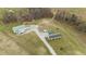 Expansive property featuring main home, large outbuilding, and long private driveway at 4194 Abattoir Rd, Angier, NC 27501