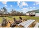 Spacious backyard with fire pit and outdoor seating, perfect for relaxing and entertaining guests at 4194 Abattoir Rd, Angier, NC 27501