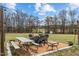 Outdoor entertaining area with chairs, tables and string lights over a gravel ground cover at 4194 Abattoir Rd, Angier, NC 27501