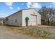 Exterior view of a white barn with a green awning and large roll-up door at 4194 Abattoir Rd, Angier, NC 27501
