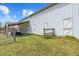 Side of a white metal barn featuring doors, covered parking, and an adjacent pasture at 4194 Abattoir Rd, Angier, NC 27501