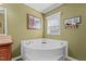 Bathroom with soaking tub and neutral wall decor at 4194 Abattoir Rd, Angier, NC 27501