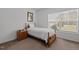Cozy bedroom with natural light, featuring a twin bed, wood furniture, and carpet flooring at 4194 Abattoir Rd, Angier, NC 27501