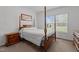 Bedroom with a four-poster bed, a nightstand, and natural light from the window at 4194 Abattoir Rd, Angier, NC 27501