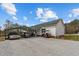 Long carport attached to home, with two cars parked underneath and a golf cart beside the driveway at 4194 Abattoir Rd, Angier, NC 27501