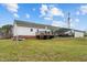 Wide backyard with lots of space featuring a carport, a back deck, and verdant grounds at 4194 Abattoir Rd, Angier, NC 27501