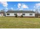 Charming single-story home with white siding and a well-maintained front lawn on a sunny day at 4194 Abattoir Rd, Angier, NC 27501