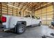 Large garage featuring a lifted white truck with ample room for car maintenance and storage at 4194 Abattoir Rd, Angier, NC 27501
