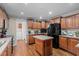 Well-lit kitchen with wood cabinets, center island, and black appliances at 4194 Abattoir Rd, Angier, NC 27501