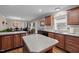 Open kitchen featuring a large island, wood cabinets and access to dining at 4194 Abattoir Rd, Angier, NC 27501