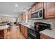 Spacious kitchen featuring wood cabinets, island, and stainless appliances at 4194 Abattoir Rd, Angier, NC 27501