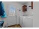 Bright laundry room featuring appliances and an exterior door at 4194 Abattoir Rd, Angier, NC 27501