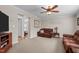 Cozy living room with neutral carpet, ceiling fan, and comfortable seating at 4194 Abattoir Rd, Angier, NC 27501