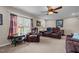 Bright living room with large window, reclining furniture, and neutral carpet at 4194 Abattoir Rd, Angier, NC 27501
