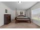 Spacious main bedroom with a four-poster bed, neutral carpet, and white walls at 4194 Abattoir Rd, Angier, NC 27501
